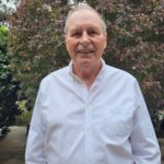 Half length close up photo of Bill Murray, standing in front of a tree